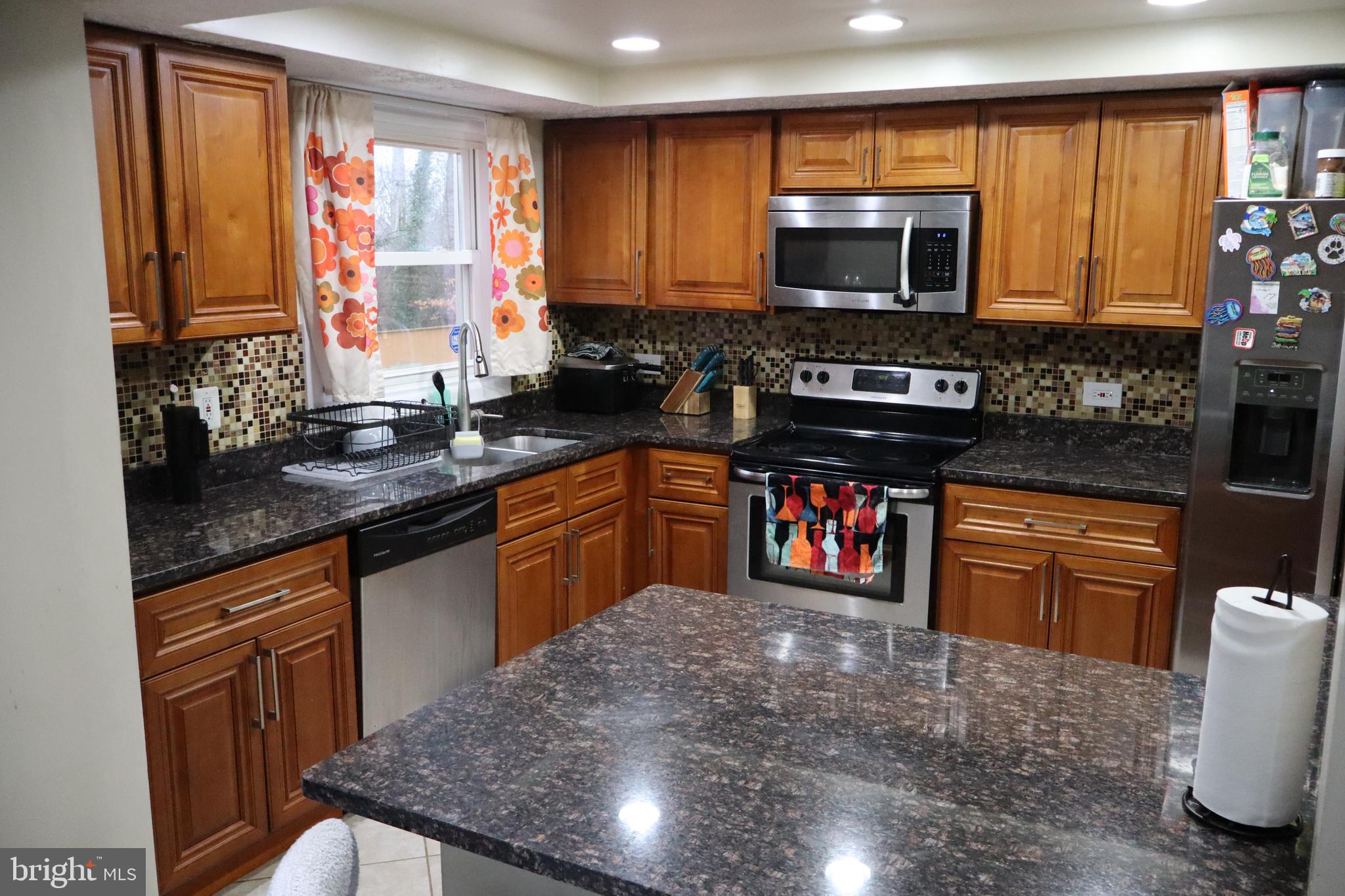 10916 Bridle Path Circle Waldorf, MD 20601 - Photo 4 of 31 a kitchen with stainless steel appliances granite countertop a stove sink microwave and cabinets