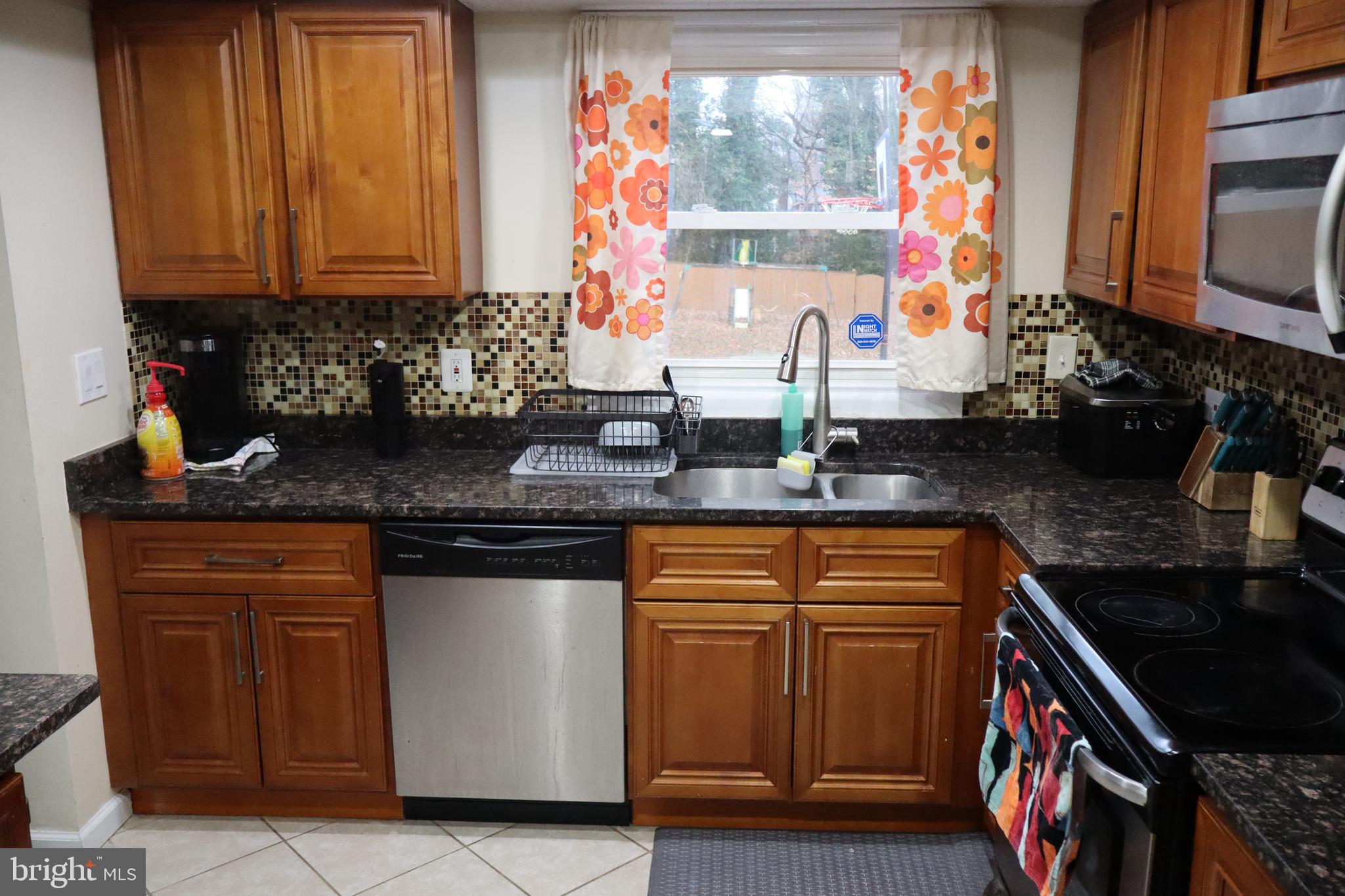 10916 Bridle Path Circle Waldorf, MD 20601 - Photo 7 of 36 a kitchen with stainless steel appliances granite countertop a sink stove and cabinets