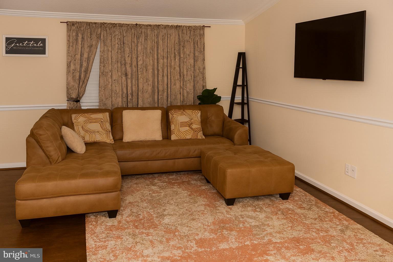 10916 Bridle Path Circle Waldorf, MD 20601 - Photo 9 of 36 a living room with furniture and a flat screen tv