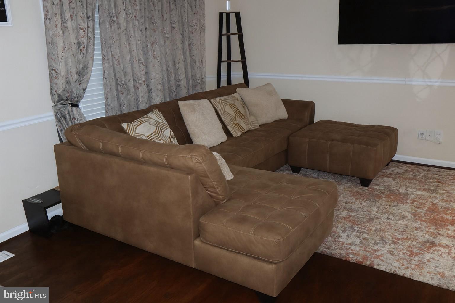 10916 Bridle Path Circle Waldorf, MD 20601 - Photo 10 of 36 a living room with couches and a night stand