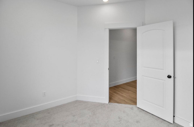 412 West 3025th Street South Logan, UT 84321 - Photo 26 of 34 Unfurnished bedroom with light carpet and baseboards