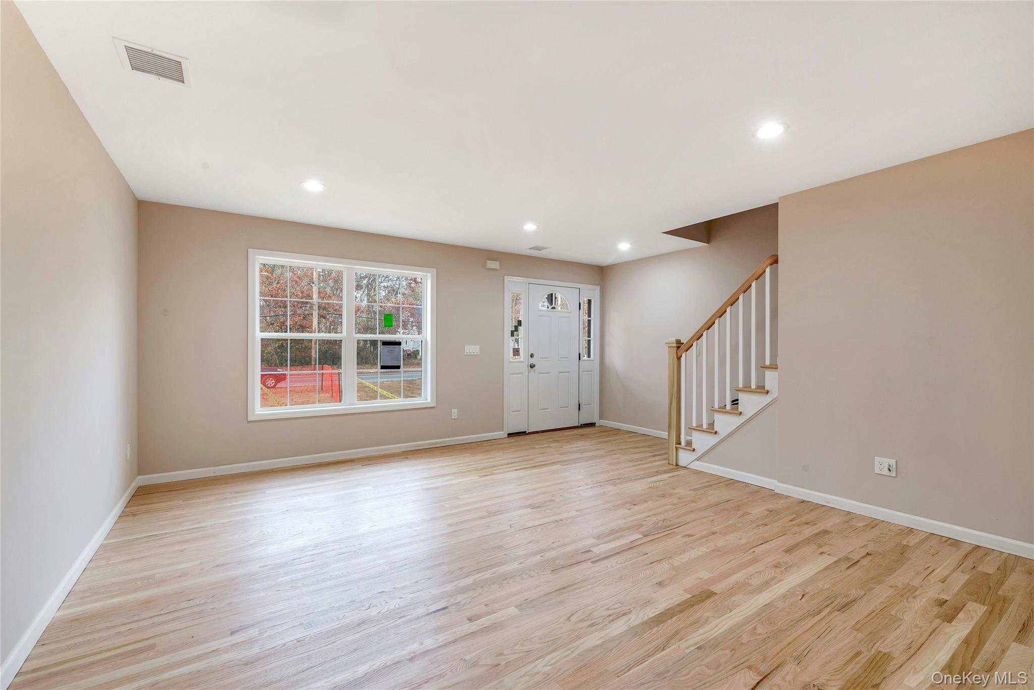487 Neighborhood Road Shirley, NY 11967 - Photo 5 of 18 Entryway with stairs, light wood finished floors, and recessed lighting
