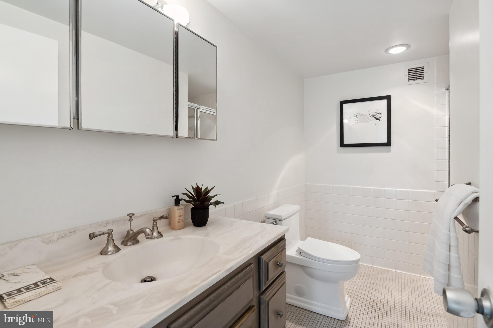 4100 Cathedral Avenue Northwest, Unit 709 Washington, DC 20016 - Photo 12 of 20 a bathroom with a sink vanity and toilet