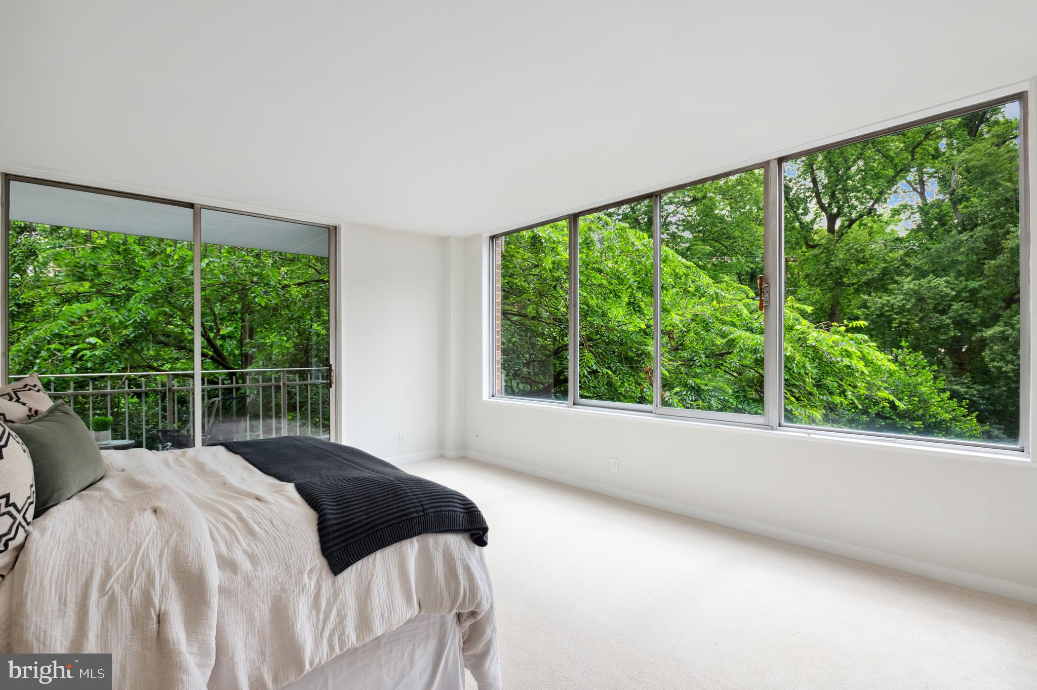 4100 Cathedral Avenue Northwest, Unit 709 Washington, DC 20016 - Photo 8 of 20 a bedroom with a bed and a large window