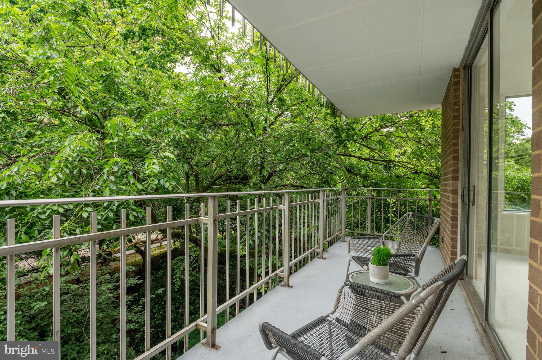 4100 Cathedral Avenue Northwest, Unit 709 Washington, DC 20016 - Photo 9 of 20 a view of a balcony with chair and wooden floor