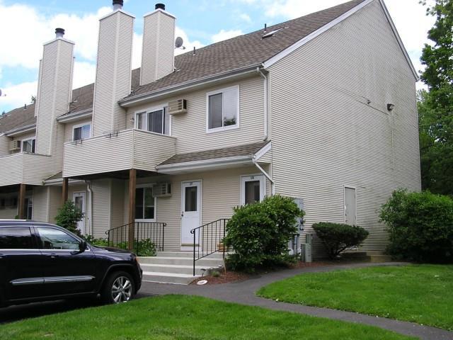 136 Pembroke Road, Unit 18 Danbury, CT 06811 - Photo 1 of 1 a front view of a house with a garden