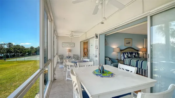 a view of a dining room with furniture a chandelier and wooden floor