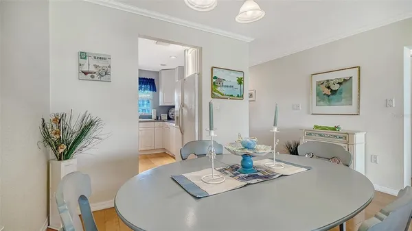 a dining room with furniture and wooden floor