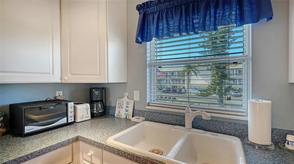 a kitchen with stainless steel appliances granite countertop a sink a stove and a wooden floors