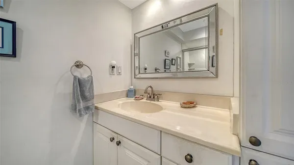 a bathroom with a sink vanity and mirror