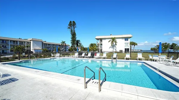 a view of a swimming pool and outdoor seating