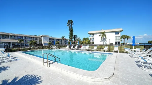 a view of a swimming pool with outdoor seating