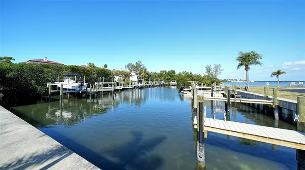 a view of a lake with boats and trees in the background