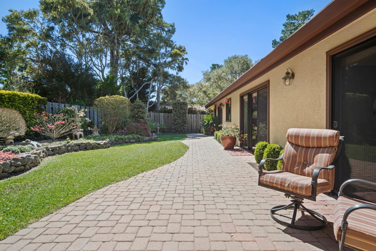 2911 Colton Road Pebble Beach, CA 93953 - Photo 41 of 46 a view of a chair and table in backyard of the house