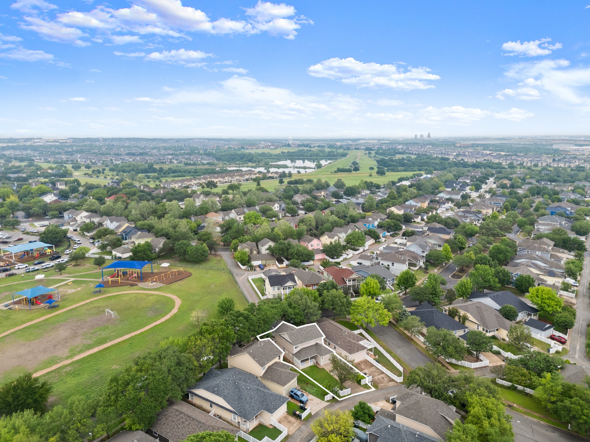 360 Sampson Kyle, TX 78640 - Photo 33 of 36 Aerial view showcasing a residential neighborhood with a large green space featuring playground equipment and a walking path