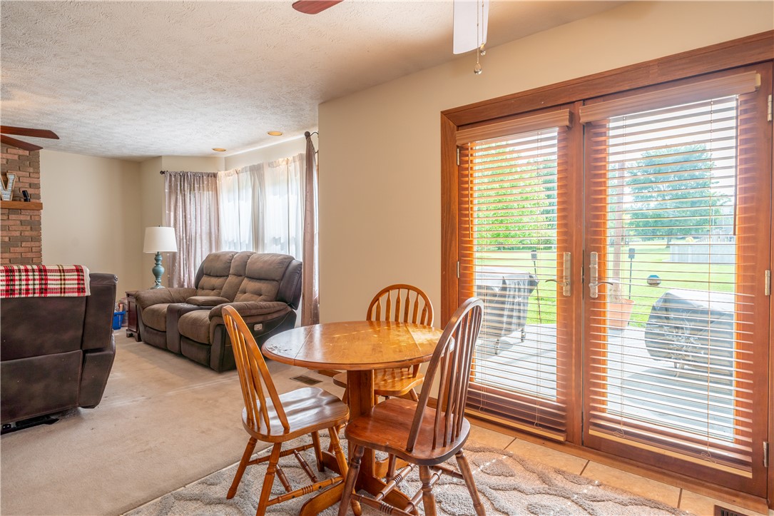3628 Petre Road Springfield, OH 45502 - Photo 9 of 52 This inviting space offers a comfortable living area adjacent to a dining nook with outdoor access.