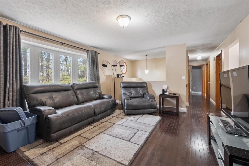 681 Teel Road Winchendon, MA 01475 - Photo 14 of 27 a living room with furniture a flat screen tv and a large window