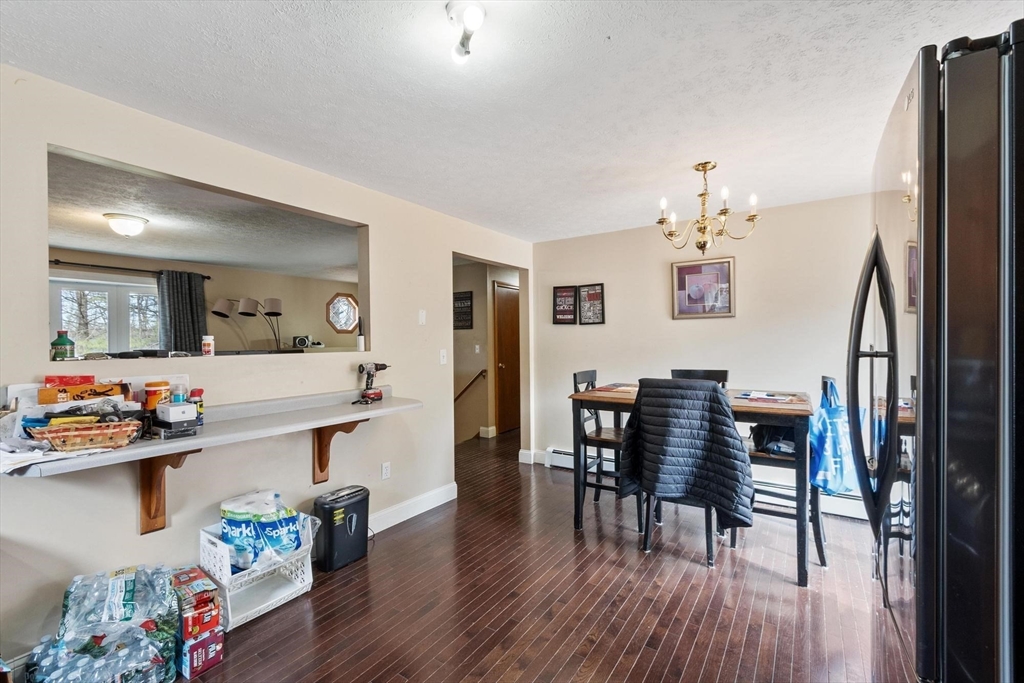 681 Teel Road Winchendon, MA 01475 - Photo 17 of 27 a view of dining room and kitchen with furniture wooden floor and a chandelier