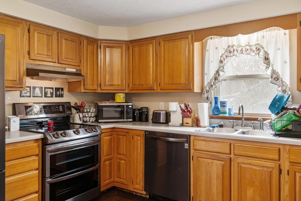 681 Teel Road Winchendon, MA 01475 - Photo 18 of 27 a kitchen with stainless steel appliances granite countertop a stove a sink dishwasher and cabinets with wooden floor