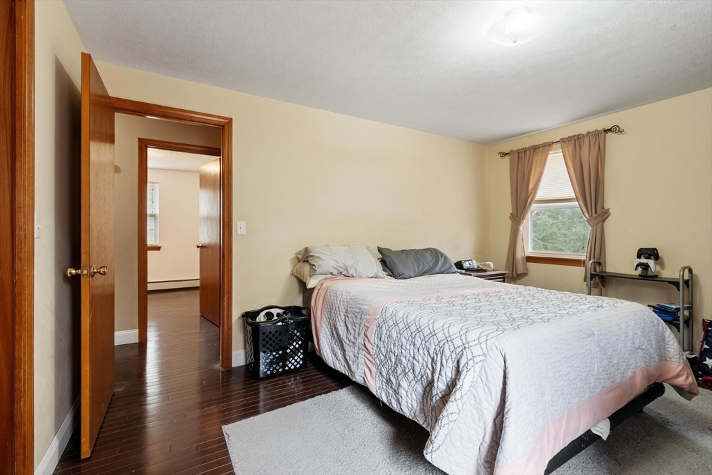 681 Teel Road Winchendon, MA 01475 - Photo 20 of 27 a bedroom with a bed and a large mirror next to a window