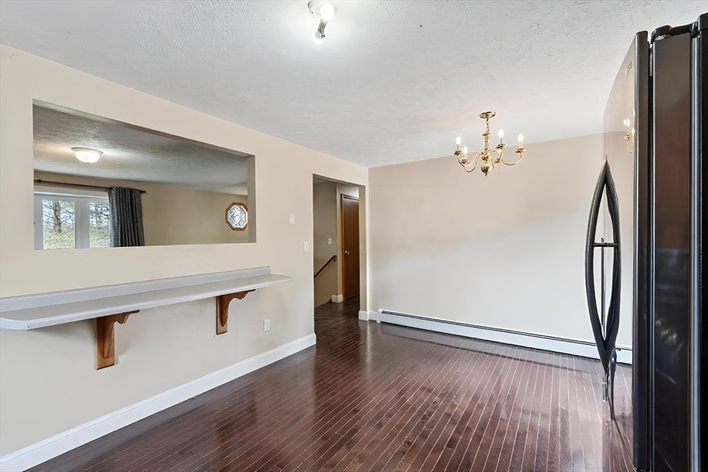 681 Teel Road Winchendon, MA 01475 - Photo 6 of 27 a view of an empty room with wooden floor and a window