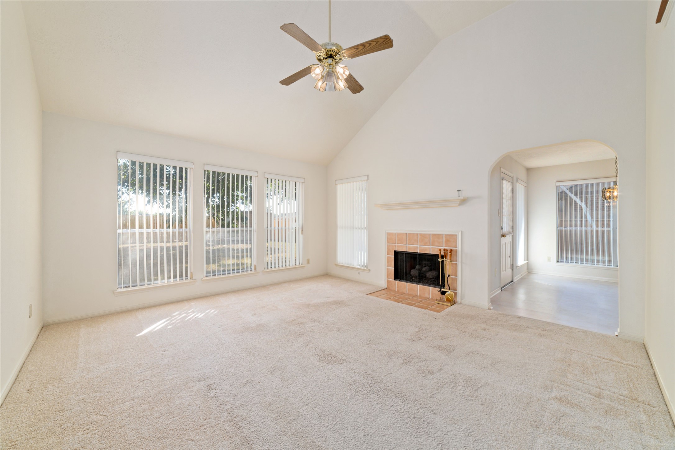 3327 Keygate Drive Spring, TX 77388 - Photo 12 of 37 a view of a livingroom with a fireplace and a chandelier fan