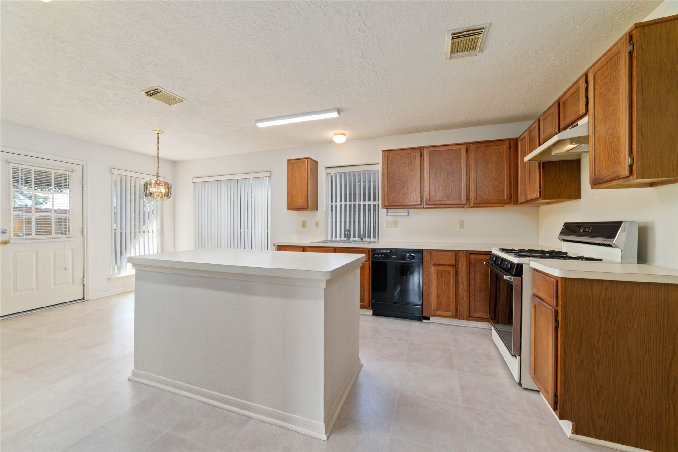3327 Keygate Drive Spring, TX 77388 - Photo 21 of 37 a kitchen with stainless steel appliances granite countertop a sink stove and refrigerator
