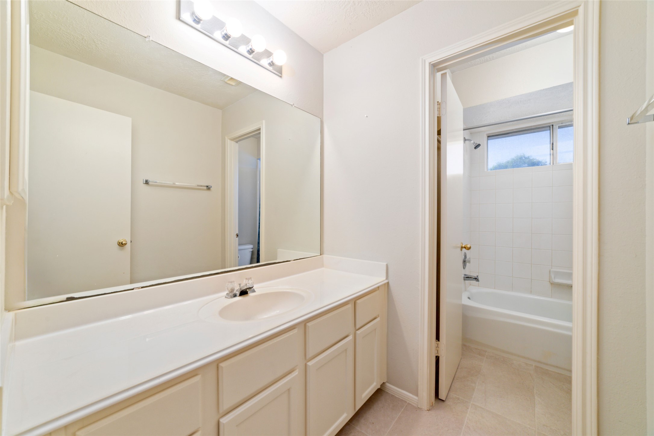 3327 Keygate Drive Spring, TX 77388 - Photo 32 of 37 a bathroom with a tub sink and a mirror