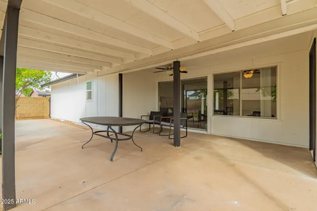 a view of a patio with table and chairs and potted plants