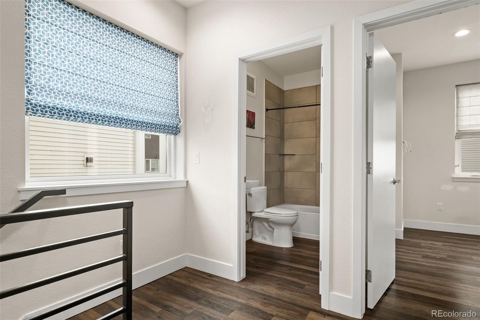 1204 South Reed Street Lakewood, CO 80232 - Photo 17 of 45 a bathroom with a toilet and a shower