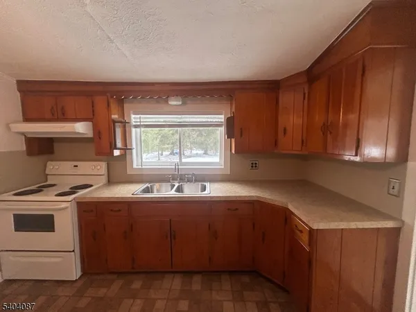 a kitchen with a sink stove and cabinets