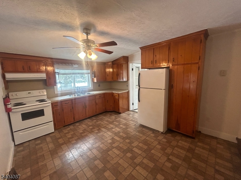 223 Goat Hill Road West Amwell, NJ 08530 - Photo 12 of 17 a kitchen with a refrigerator and a stove top oven
