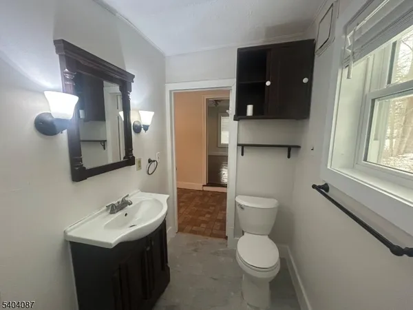 a bathroom with a toilet sink and mirror