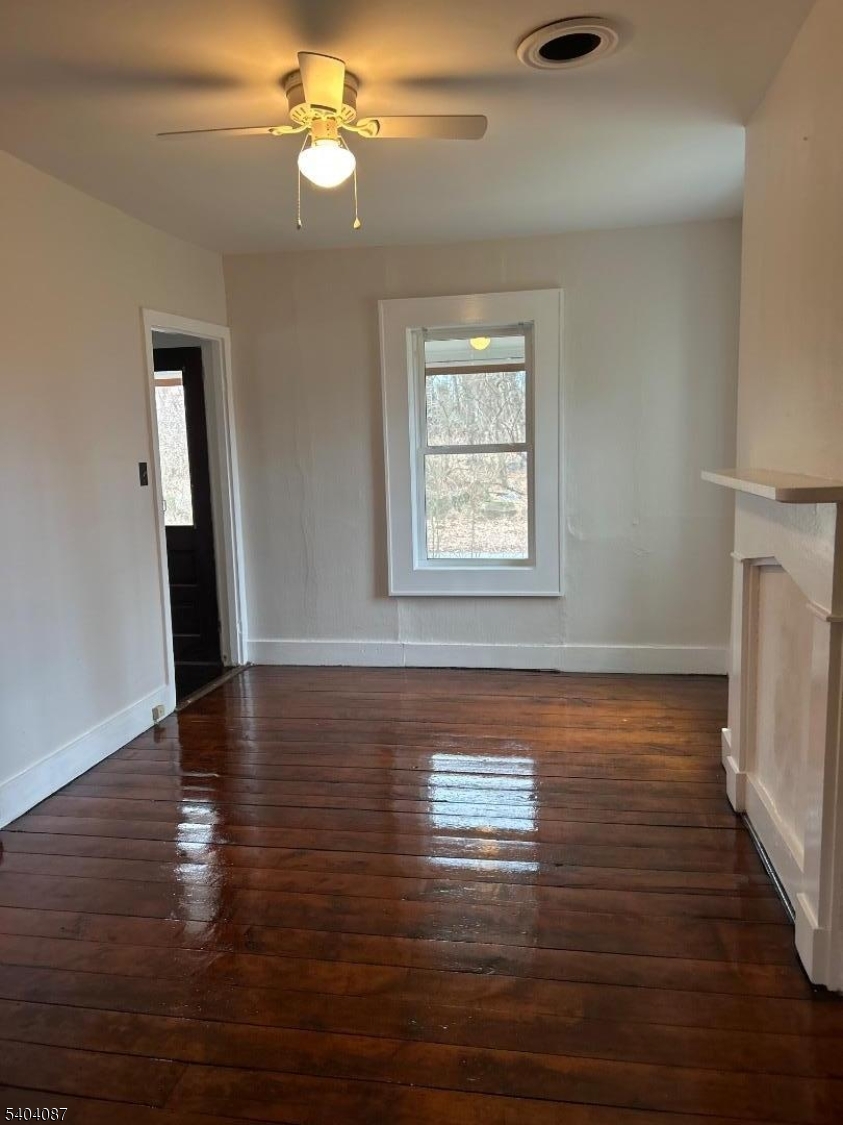 223 Goat Hill Road West Amwell, NJ 08530 - Photo 3 of 17 a view of empty room with wooden floor and fan