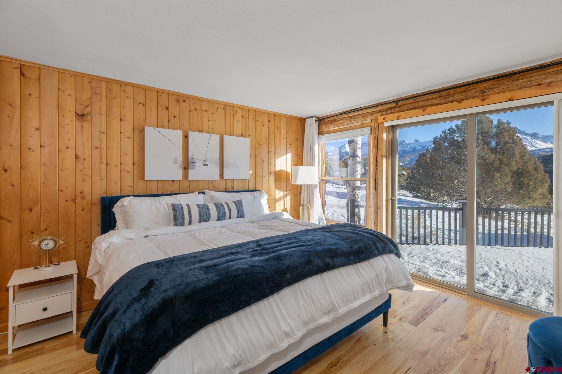 125 County Road 7A Ridgway, CO 81432 - Photo 12 of 40 a spacious bedroom with a bed and a window