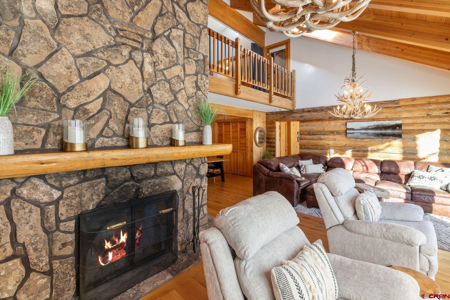 125 County Road 7A Ridgway, CO 81432 - Photo 35 of 40 a living room with furniture a fireplace and a flat screen tv