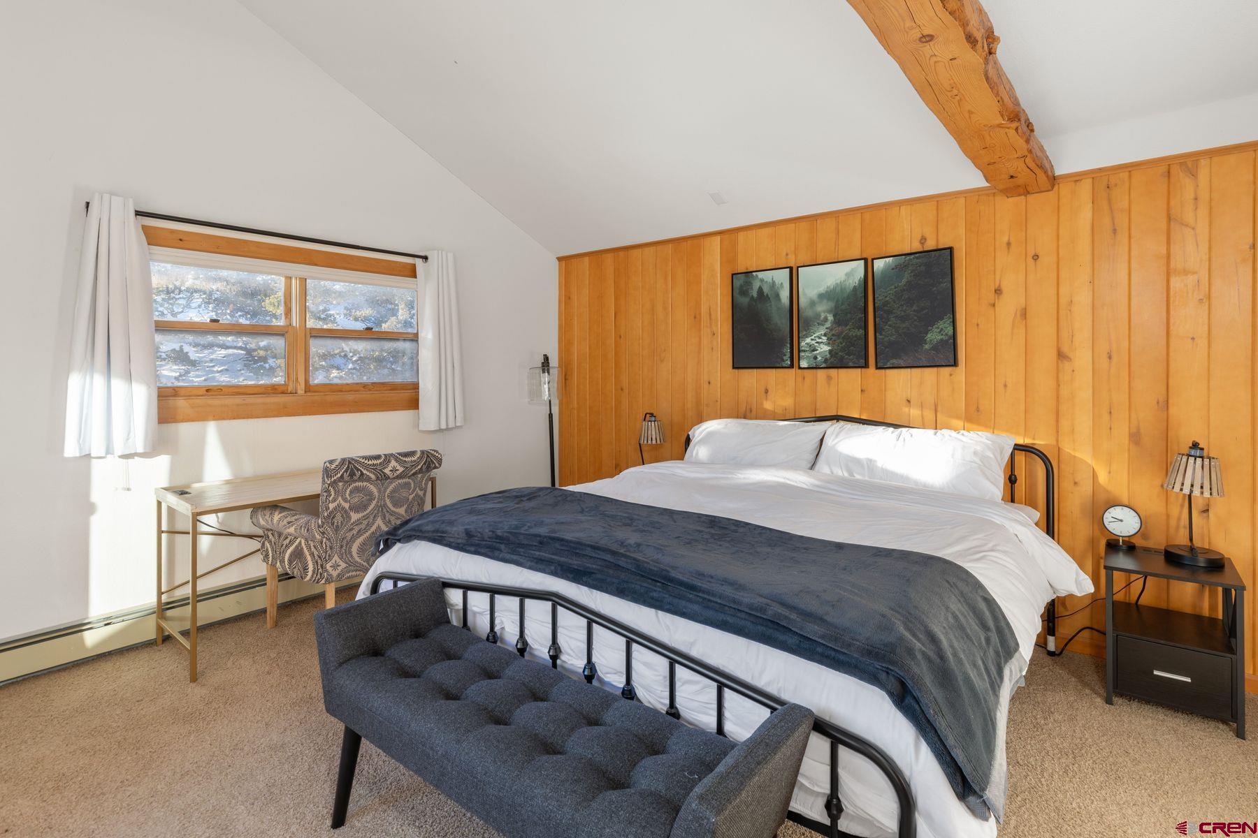 125 County Road 7A Ridgway, CO 81432 - Photo 36 of 40 a bedroom with a bed and wooden floor