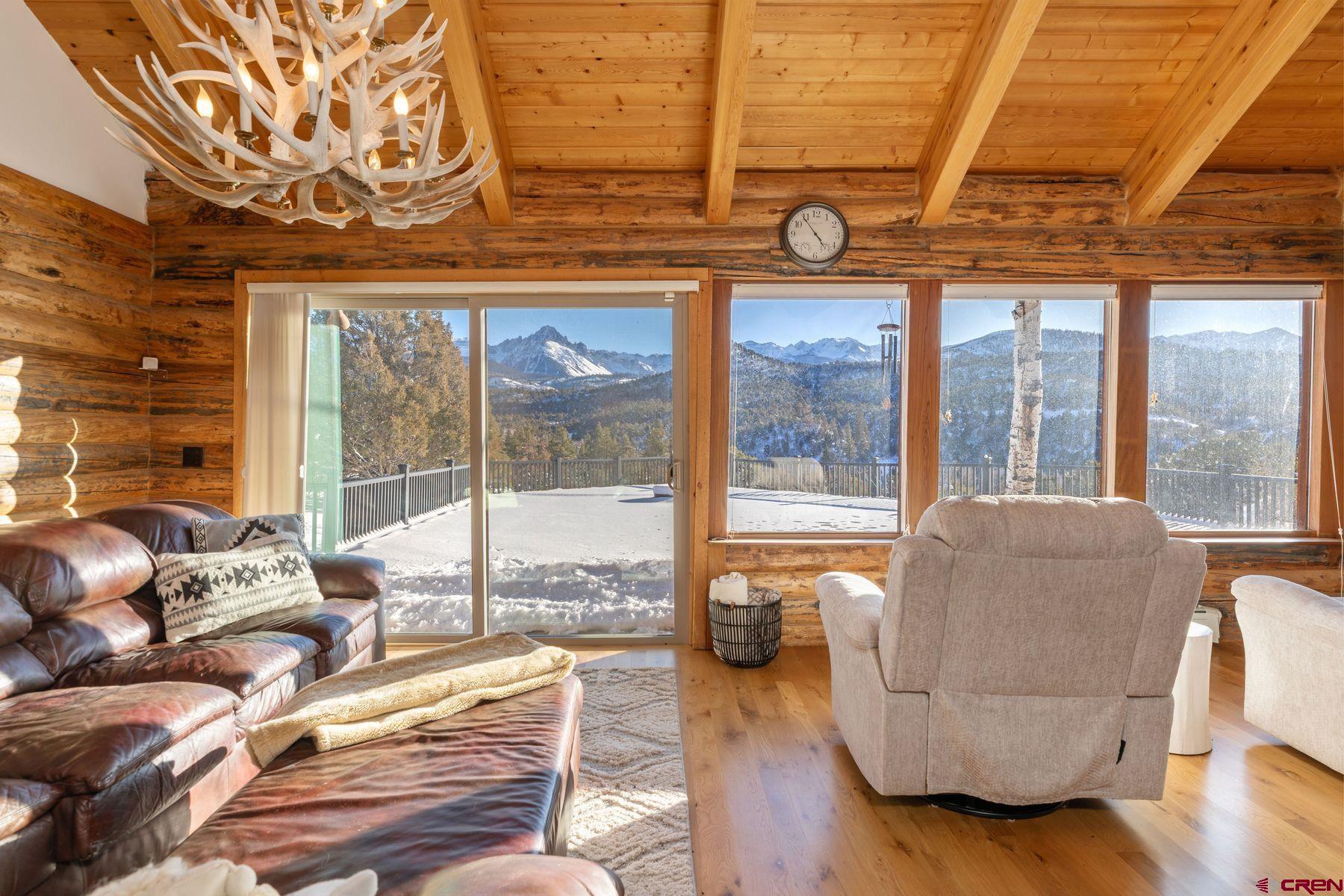 125 County Road 7A Ridgway, CO 81432 - Photo 6 of 40 a living room with furniture and a floor to ceiling window