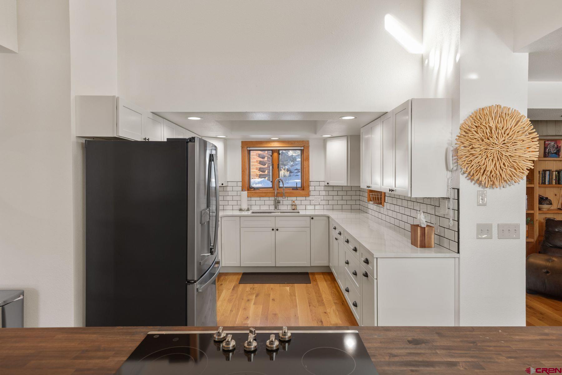 125 County Road 7A Ridgway, CO 81432 - Photo 9 of 40 a kitchen with a refrigerator and countertop