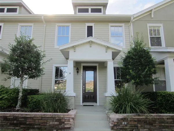 a front view of a house with plants