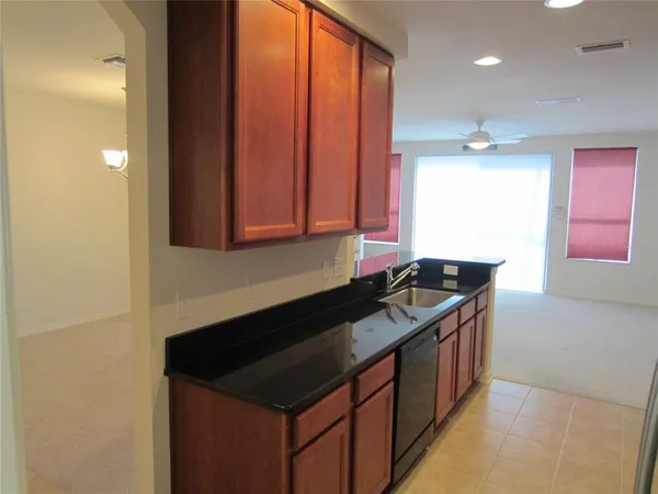 a kitchen with a sink and a stove top oven