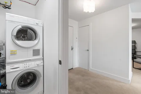 a view of a hallway with washer and dryer