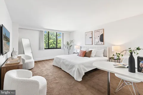 a bedroom with a bed and couch