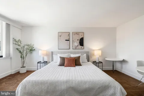 a bedroom with a bed and lamps