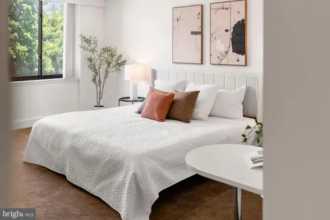 a bedroom with a bed and window