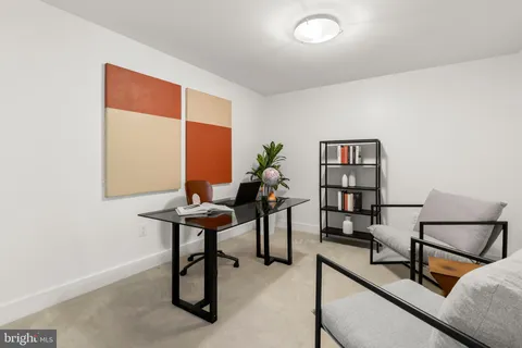 a reading room with furniture and a window