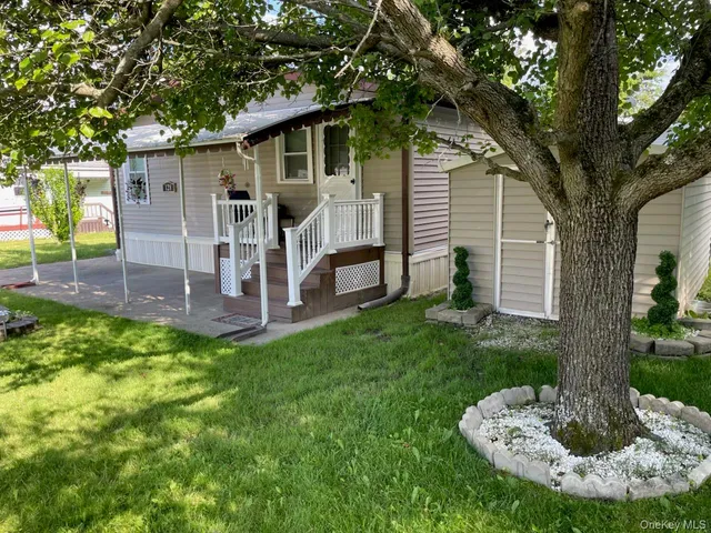 a view of a house with backyard tub and tree s