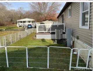 a view of a house with backyard and deck