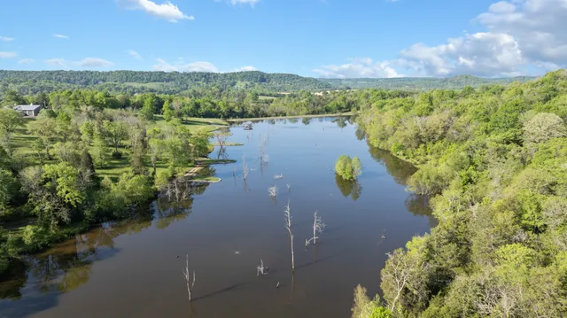 a dining hall with stainless steel appliances kitchen island granite countertop a sink and cabinets