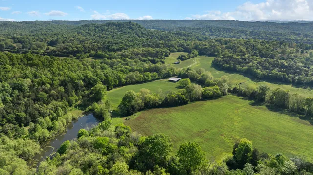 a spacious bathroom with a double vanity sink a mirror and a bathtub